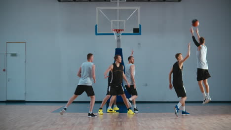 High-school-team-playing-basketball-indoors,-practicing-combinations-and-drills.-4K-UHD